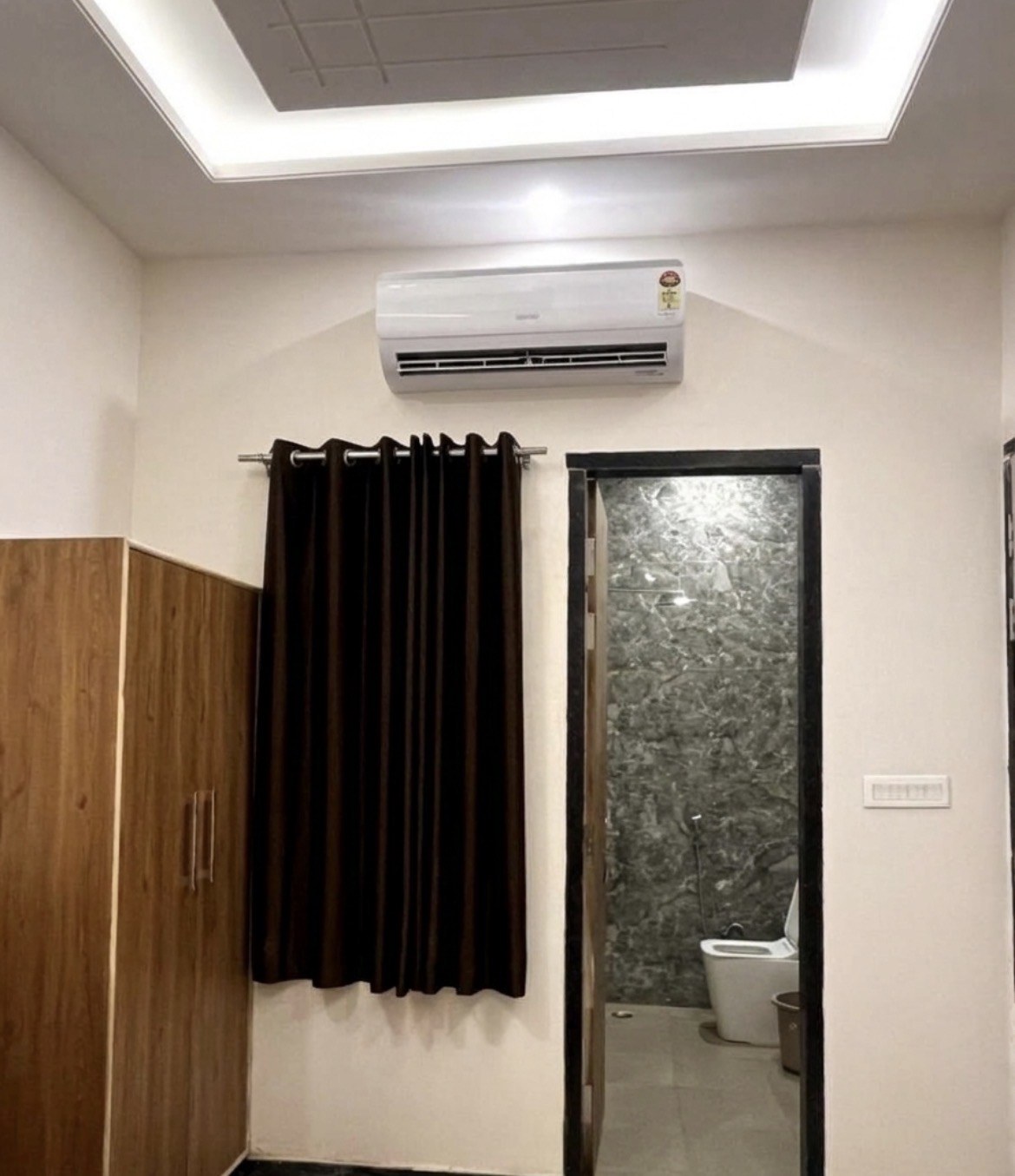 Climate-controlled split air conditioning, dark blackout curtains and clean tiled attached bathroom