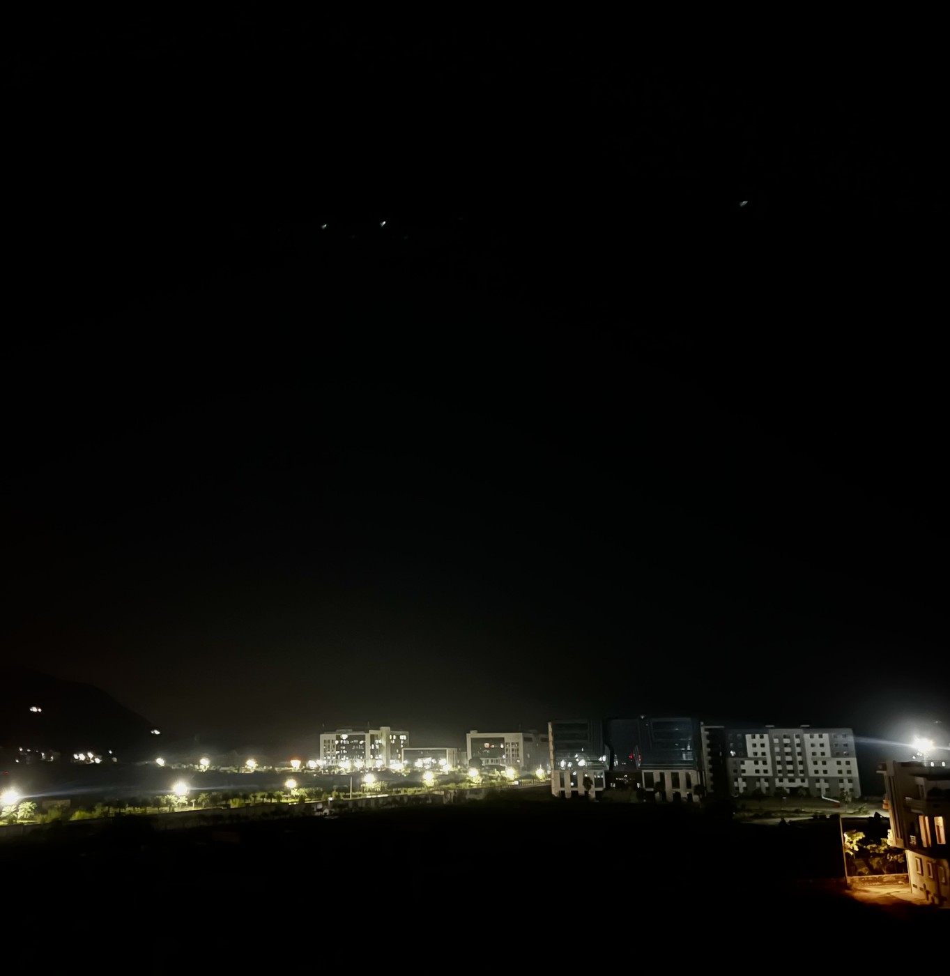 Tranquil night view of Achrol skyline with illuminated campus and hills