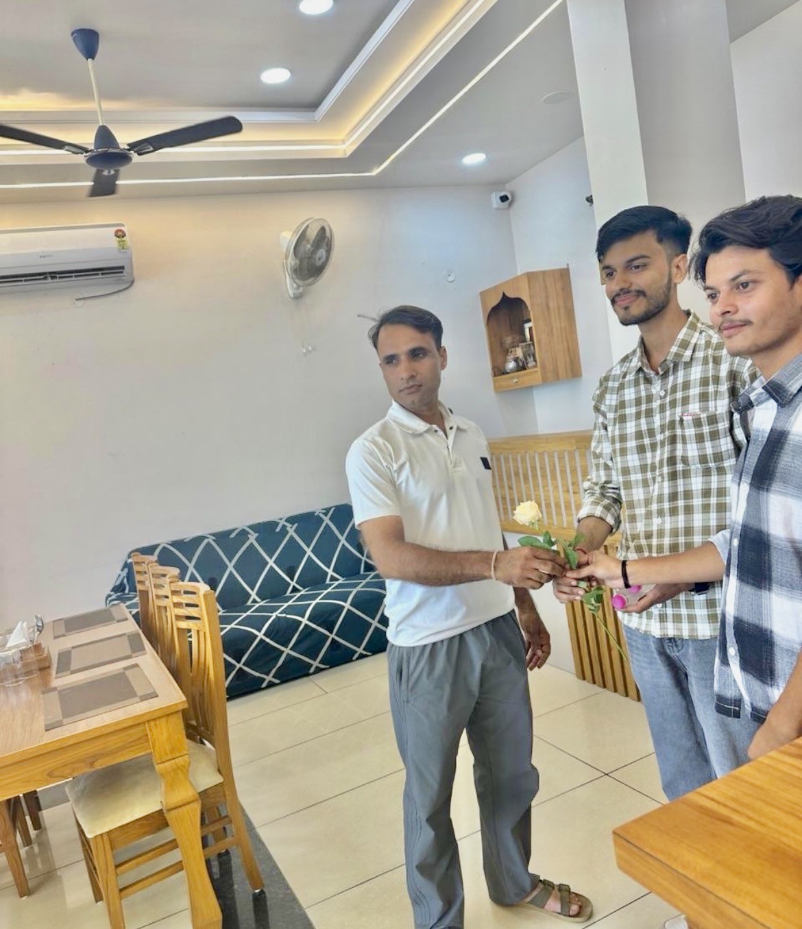 Friendly hotel staff extending warm Rajasthani hospitality to guests